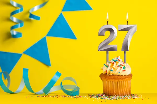 Birthday candle number 27 with cupcake - Yellow background with blue pennants