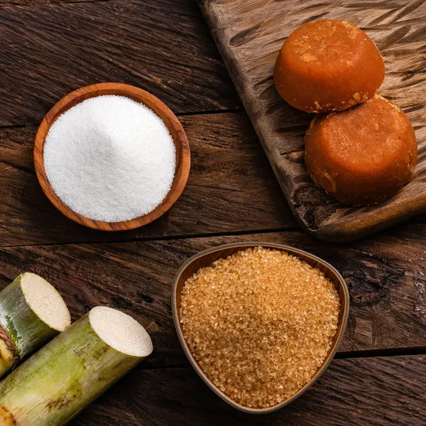 stock image Panela, brown and white sugar with the stems of sugar cane - Saccharum officinarum