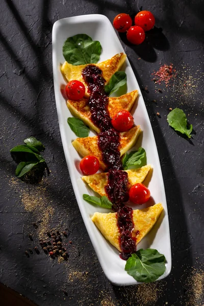 Grilled papialpa cheese with red fruit jam with cherry tomatoes and basil