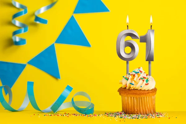 Birthday candle number 61 with cupcake - Yellow background with blue pennants