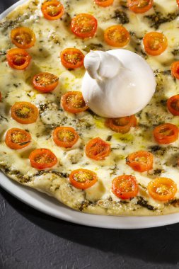 Domatesli pizza üzerine taze peynirli burrata.