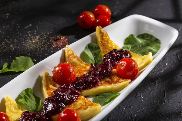 Grilled papialpa cheese with red fruit jam with cherry tomatoes and basil