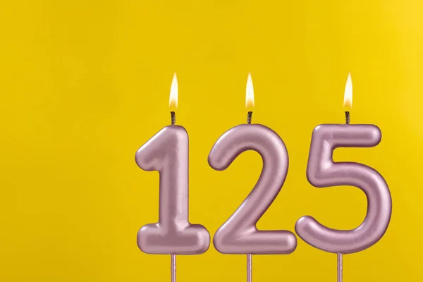 Birthday candle number 125 - Birthday celebration on yellow background