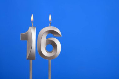 Doğum günü numarası 16 - Mavi arkaplanda mum yanıyor