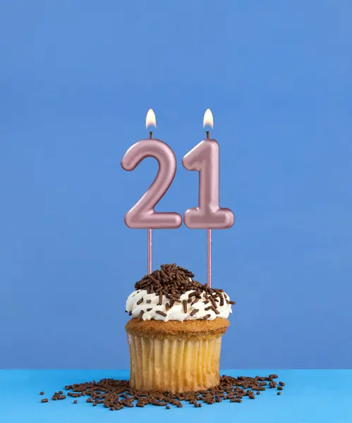 Birthday candle with cupcake on blue background - Number 21