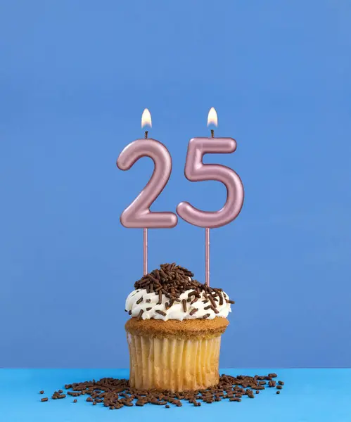 Birthday candle with cupcake on blue background - Number 25