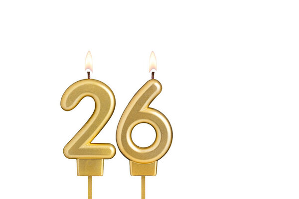 Golden number 26 birthday candle on white background