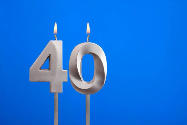 Birthday number 40 - Candle lit on blue background