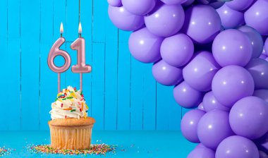 61 numaralı mum, kek ve balonlarla birlikte doğum günü kartı.