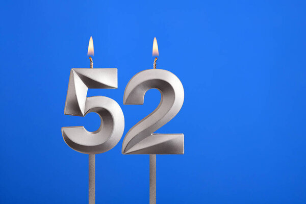 Birthday number 52 - Candle lit on blue background