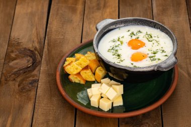 Changua is a soup made with milk, egg and onion - Typical Colombian breakfast clipart