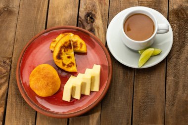 Boyacense breakfast with arepa, cheese, almojabana and aguapanela with lemon clipart