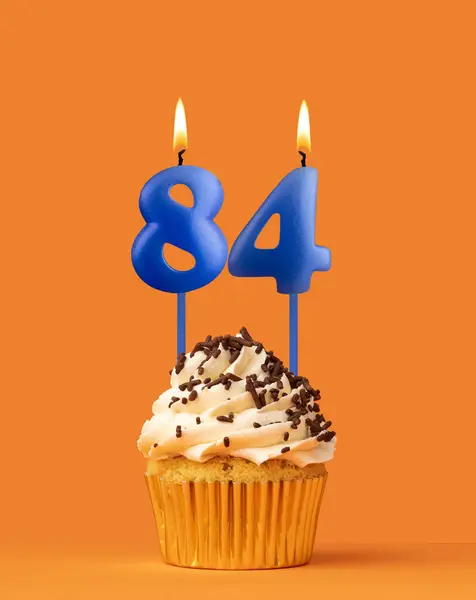 Stock image Blue birthday candle and cupcake - Number 84