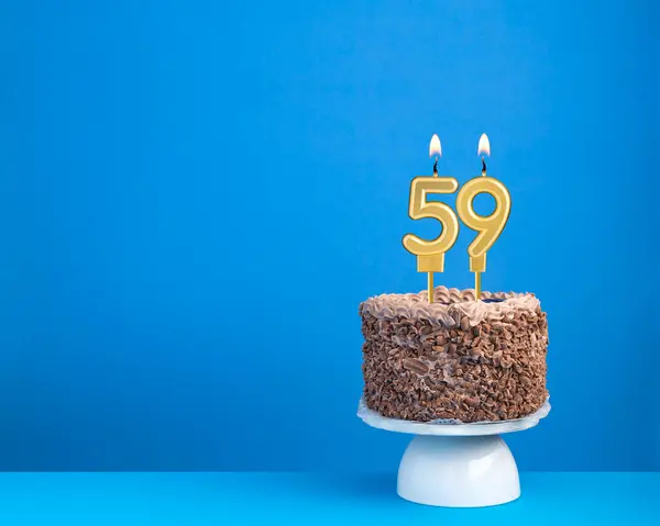 stock image Birthday celebration with candle 59 - Chocolate cake on blue background