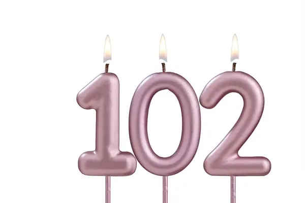 stock image Lit birthday candle - Candle number 102 on white background