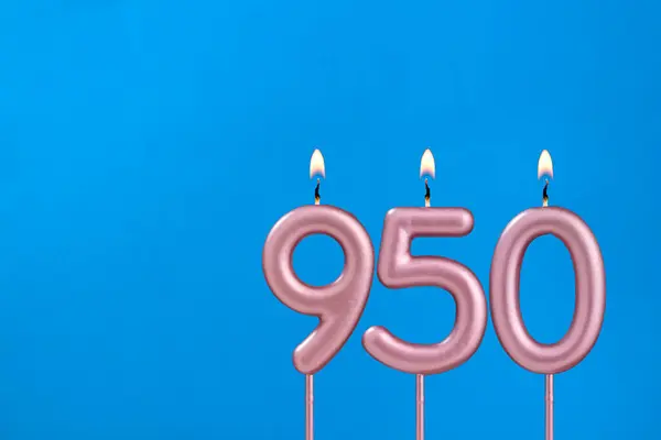 stock image Number 950 - Burning anniversary candle on blue foamy background