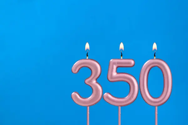 stock image Number 350 - Burning anniversary candle on blue foamy background