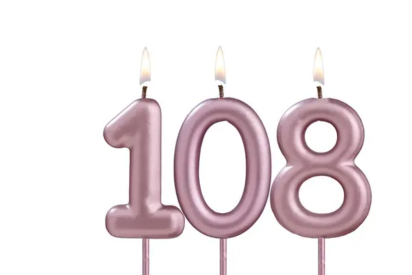 stock image Lit birthday candle - Candle number 108 on white background