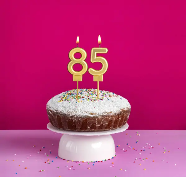 stock image Birthday cake with number 85 candle on pink background