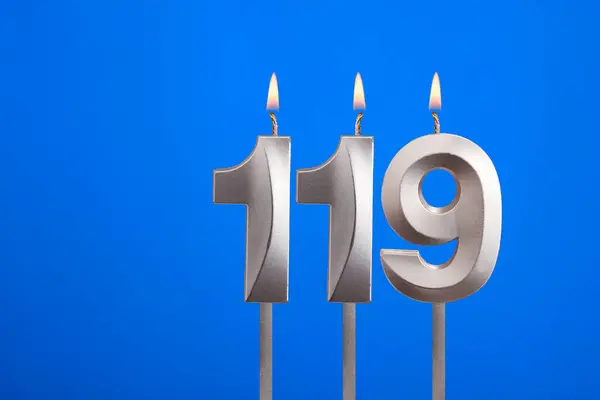 stock image Birthday candle number 119 - Celebration card on blue background