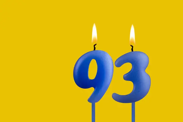 stock image Blue birthday candle on yellow background - Number 93