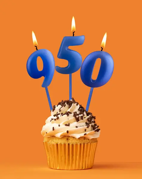 stock image Blue candle number 950 - Birthday cupcake on orange background