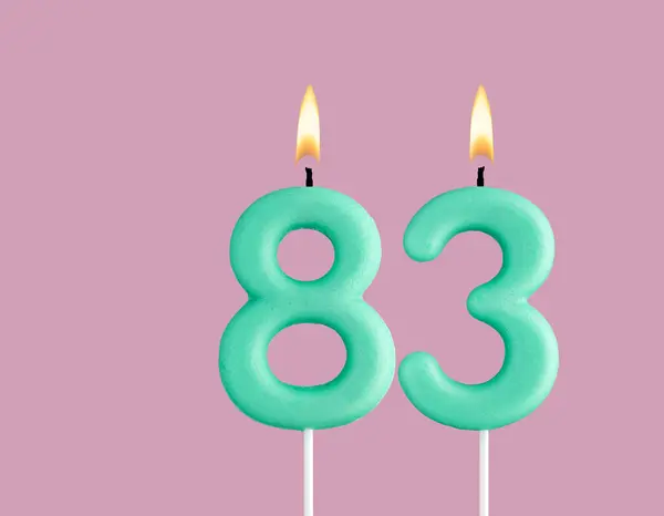 stock image Birthday card with green number 83 candle - Pastel pink background