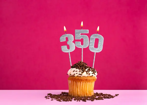 stock image Birthday celebration with candle number 350 - Chocolate cupcake on pink background