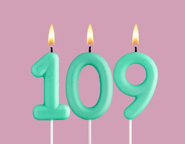 stock image Birthday card with green number 109 candle - Pastel pink background