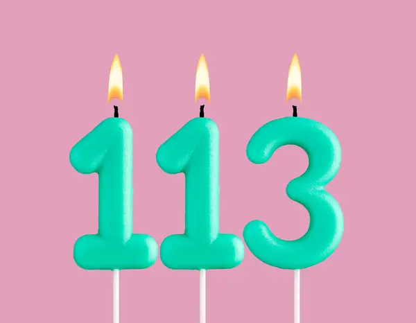 stock image Birthday card with green number 113 candle - Pastel pink background