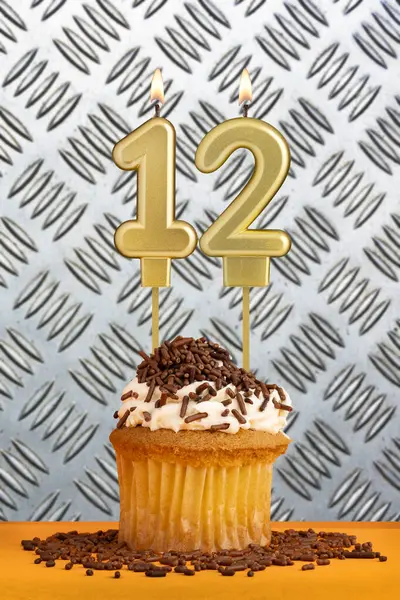 stock image Birthday candle number 12 - Industrial metallic background.