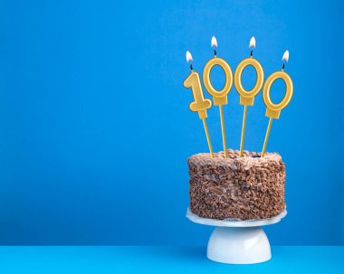 Mum 1000 ile doğum günü kutlaması - Mavi arka planda çikolatalı pasta