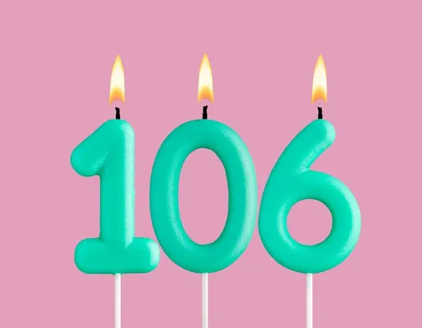 stock image Green candle number 106 - Birthday card on pastel pink background