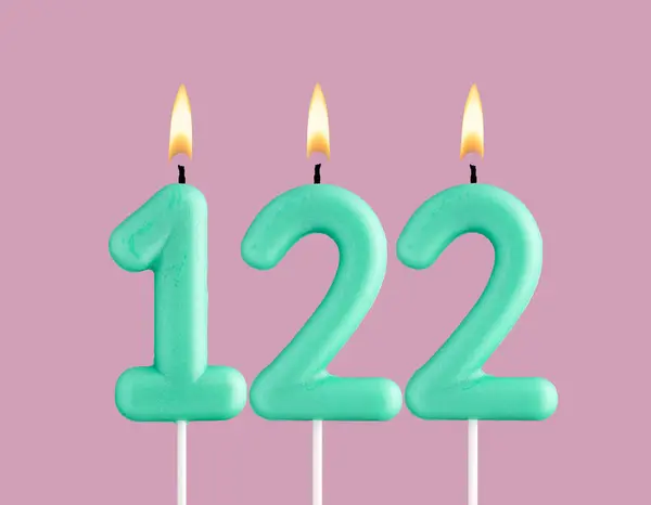 stock image Green candle number 122 - Birthday card on pastel pink background