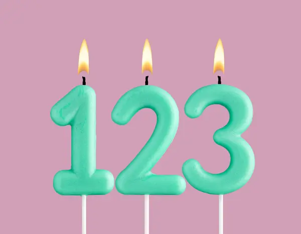 stock image Birthday card with green number 123 candle - Pastel pink background