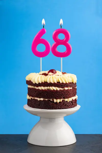 stock image Red velvet birthday cake with number 68 candle