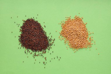 Heap of dried yellow and brown mustard seeds. clipart