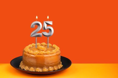 Birthday candle number 25 - Cake with dulce de leche frosting. clipart