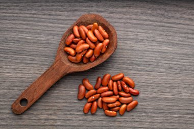 Organic beans on a spoon - Nutritious dried beans. clipart