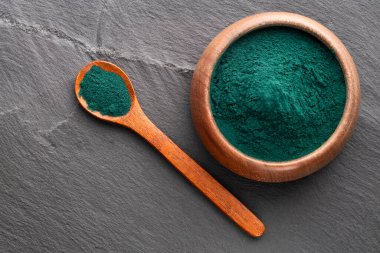 Kâse ve kaşıkta organik spirulina tozu - sağlıklı yiyecek.