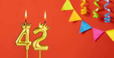 42 numaralı mum - Turuncu arka planda flama ile doğum günü kutlaması