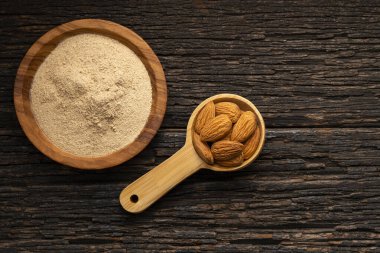 Prunus dulcis - Organik zemin kurutulmuş bademler bir kaşık ve kâsede