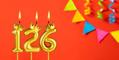 126 numaralı mum - Turuncu arka planda flama ile doğum günü kutlaması