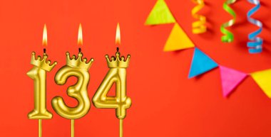 134 numaralı mum - Turuncu arka planda flama ile doğum günü kutlaması