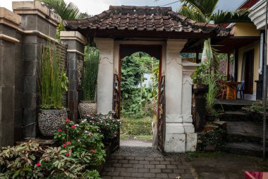 Traditional balinese carved door. Bali style furniture with mini garden