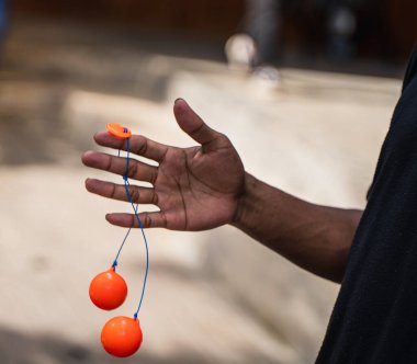 Close up boy hand play the Lato-lato game which is a type of traditional game that can be found in Indonesia.