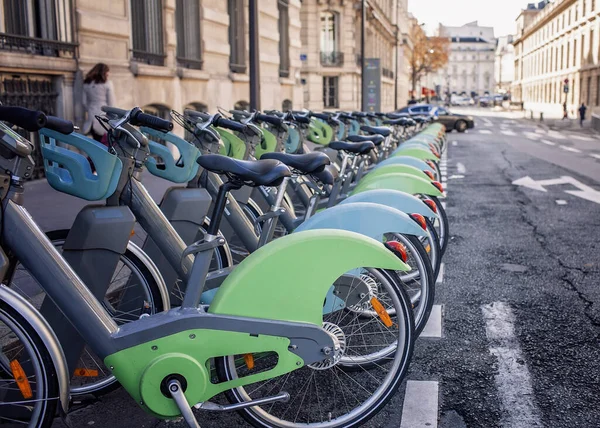 stock image Row of electro bicycles for rent on a street of Paris, France, sharing point, urban transport and environmentally conscious travel choice, ecological transportation concept