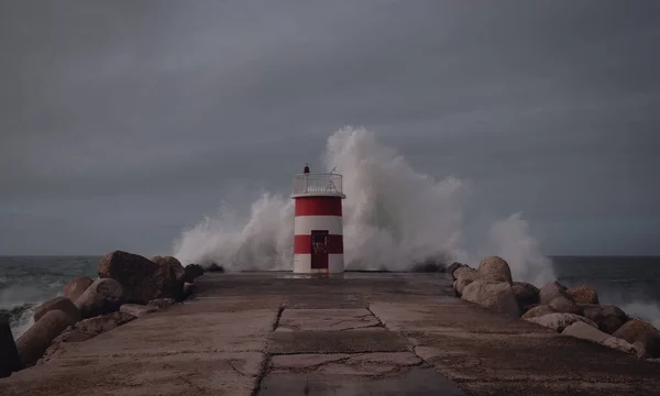 storm, lighthouse and waves, view from the portuguese coast
