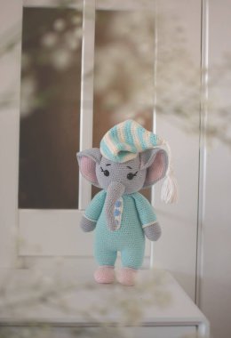 amigurumi handmade knitted elephant toy in blue pajamas