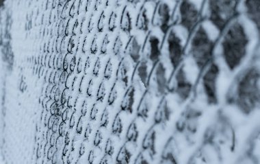 metal snow-covered grating close-up